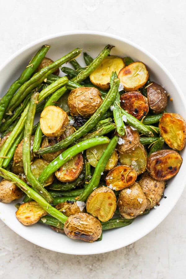 Roasted Potatoes and Green Beans in a white serving bowl.