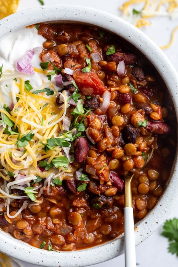 lentil chili topped with cheese, sour cream and fresh cilantro