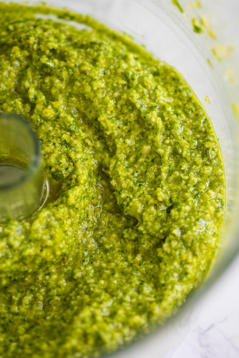 up close shot of pesto in a food processor