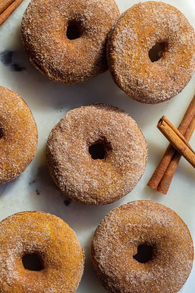 cinnamon sugar baked pumpkin donuts on a tray.