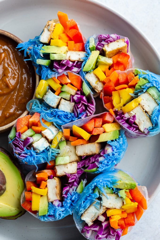 spring rolls made with lots of colorful veggies, and rice noodles that have been dyed blue with blue spirulina. There's also chunks of tofu in them.