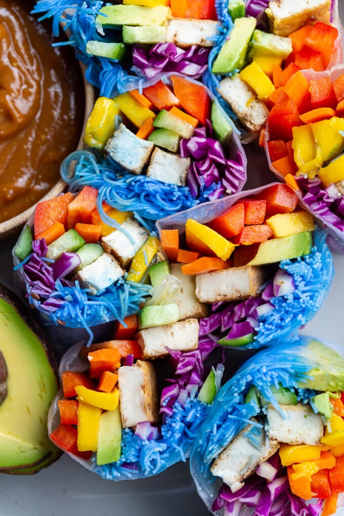 spring rolls made with lots of colorful veggies, and rice noodles that have been dyed blue with blue spirulina. There's also chunks of tofu in them.